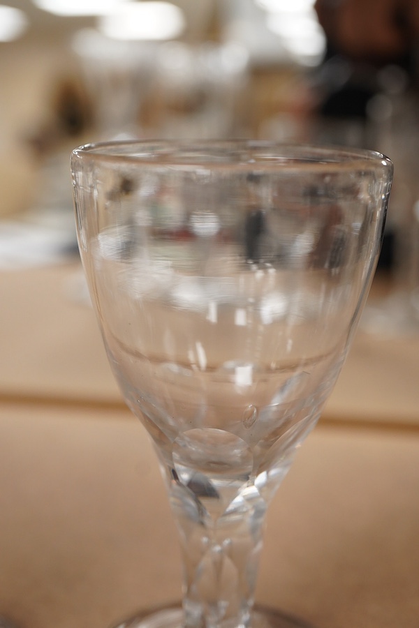 Four Georgian wine glasses, three with engraved bowls, three with faceted stems, and one with an air twist knopped stem and stepped foot, tallest 16cm